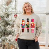 Nutcracker Faux Sequins DTF Heat Transfer, colorful sequin nutcracker Christmas sweater worn by smiling woman in a greenhouse.