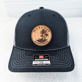 It's 5 o'clock Somewhere Round Leather Hat Patch, round leather patch featuring a palm tree and sunset design with text.