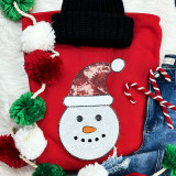 Sequin Snowman Patch, festive holiday decorated clothing with a snowman face made of sequins, wearing a Christmas hat, surrounded by holiday decorations.