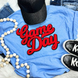 NO SPORT Red Game Day Chenille Patch, red embroidered patch with a bold script font displayed on a blue t-shirt surrounded by casual accessories and sports shoes.