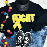 Yellow Ribbon Fight Sequins Chenille Patch, a sparkly yellow ribbon patch with sequins on a black sweatshirt.