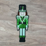 GREEN Nutcracker Sequins Embroidered Patch, a decorative patch featuring a nutcracker character in vibrant green sequins with embroidered details.