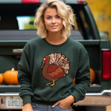 Sequin Turkey Patch, a colorful embroidered turkey patch with glittery sequins on a dark green sweatshirt worn by a woman standing outdoors near a vehicle with pumpkins in the background.
