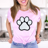 Dog Paw White Chenille Patch, white and black embroidered pet paw print patch on a pink T-shirt