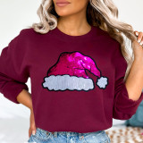 Sequin Santa Hat Patch, glittery pink Santa hat patch sewn onto a burgundy sweatshirt.