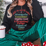 And He Will Be Called Wonderful Counselor Mighty God Everlasting Father Prince of Peace DTF Heat Transfer, colorful religious text on a black sweatshirt worn by a woman during Christmas celebration.