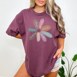 Daisy Affirmation DTF Heat Transfer, colorful flower design with words Hope, Kindness, Peace, Love, Trust, Beauty, and Together on a woman's maroon t-shirt.