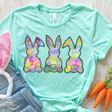 Rainbow Bunnies DTF Heat Transfer, colorfully decorated bunny silhouettes on a mint green T-shirt.