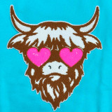 Shaggy Cow Chenille Patch, cute cartoon of a cow with shaggy brown and white fur and pink heart-shaped eyes on a blue background.