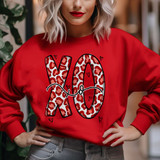 XO Leopard DTF Heat Transfer, a vibrant red sweatshirt with a large leopard-print XO design and small heart accents.