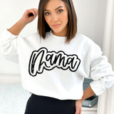 Mama Cursive Distressed DTF Heat Transfer, a woman wearing a white sweatshirt with a black distressed cursive 'Mama' design.