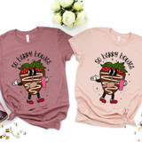So Berry Boujee DTF Heat Transfer on pink and mauve t-shirts with a cartoon strawberry character holding a pink drink