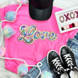 RAINBOW LOVE Sequin Patch, colorful rainbow and love design on pink fabric with sneakers, denim, and decorative items.