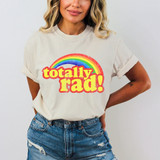 Totally Rad! DTF Heat Transfer, colorful rainbow design with 'totally rad!' text printed on a woman's T-shirt.