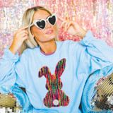 Rainbow Bunny Chenille Patch, colorful bunny design applique on blue sweatshirt with heart-shaped sunglasses and iridescent disco balls around.