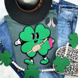 Trendy Shamrock Chenille Patch, green shamrock design with smiling face and arms holding a marshmallow skewer and pink cup, embroidered on fabric.