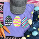Sequin Easter Eggs Pocket Sized Patch BUNDLE, colorful sequin Easter egg patches with zigzag and stripe patterns on a purple fabric background along with Easter-themed decorations.