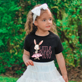 Little Bunny Tutu DTF Heat Transfer, young girl wearing a cute black T-shirt with a bunny graphic and pink tutu design in an outdoor setting.