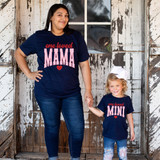 One Loved Mini DTF Heat Transfer, woman and girl wearing matching navy blue T-shirts with pink and red text and hearts, standing in front of rustic wood background.