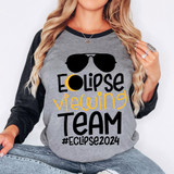 Eclipse Viewing Team DTF Heat Transfer, a woman wearing a gray and black long sleeve shirt with a sunglasses graphic and the text 'Eclipse Viewing Team #Eclipse2024' in black and yellow.
