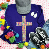 Tie Dye Cross Chenille Patch, colorful embroidered cross patch on a purple sweatshirt.