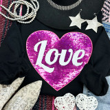 Large HOT PINK LOVE Sequin Patch, close-up of a vibrant pink heart-shaped sequin patch with the word 'Love' in white, surrounded by fashion accessories on a black background.