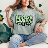 Lucky Mama Retro DTF Heat Transfer, a woman wearing a graphic t-shirt with green bold Lucky and black Mama text, sitting on a couch with St. Patrick's Day decorations.