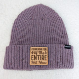 Coordinator Of The Entire Shit Show Leather Hat Patch, a knit purple beanie hat with a leather patch that reads 'Coordinator Of The Entire Shit Show.'