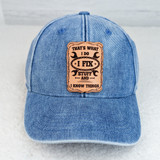 That's What I Do Leather Hat Patch, blue denim cap with a tan leather patch featuring the quote 'That's What I Do I Fix Stuff and I Know Things' in black text.