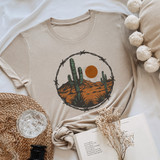 Desert Barbed Wire DTF Heat Transfer, desert landscape design with cacti, mountain, and sun on a beige t-shirt.