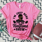 I'm Just Here For The Halftime Show LVIII DTF Heat Transfer, pink T-shirt with a graphic of a man and footballs, and text about the halftime show.