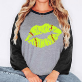 Softball Lips DTF Heat Transfer, graphic design of bright green lips with red baseball stitches on a women's casual gray and black sweatshirt.