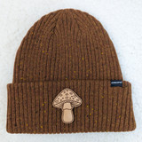 Big Mushroom Leather Hat Patch, brown knitted beanie hat with speckled yellow accents and a mushroom patch decoration.