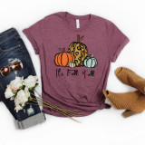 It's Fall Ya'll Pumpkins Screen Print Heat Transfer, showcasing a graphic t-shirt with pumpkins and fall-themed text, surrounded by denim jeans, sunglasses, flowers, and patterned ankle boots on a white background.