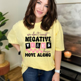 We Don't Accept Negative Vibes Here Move Along DTF Heat Transfer, a woman wearing a yellow T-shirt with the phrase 'we don't accept negative vibes here move along' in colorful and bold letters.