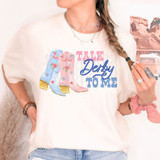 Talk Derby To Me DTF Heat Transfer, colorful cowboy boots illustration with pink and blue flowers on a woman's T-shirt.