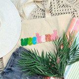 Weekend Chenille Patch, colorful embroidered patch with the word 'Weekend' on a beige tote bag amidst summer fashion accessories and greenery.
