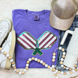 Pickle Ball Double Paddles Sequin Patch, colorful sequin decorated double paddle design on a purple T-shirt display with sneakers, a glitter cap, and accessories.