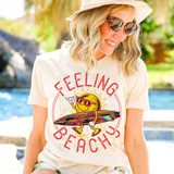 Feeling Beachy Surfboard DTF Heat Transfer, cheerful sun character with sunglasses holding a surfboard with hibiscus flowers, and the text 'Feeling Beachy' in bright red font.