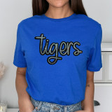 Tigers Sequin Patch, close-up of a vibrant blue t-shirt featuring a sparkling sequined 'Tigers' patch on the front.