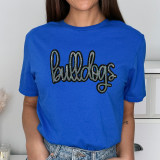 Bulldogs Sequin Patch, close-up of a woman wearing a bright blue t-shirt with a colorful sequined 'bulldogs' patch embroidered on the front.