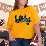 Bulldogs Sequin Patch, embroidered patch featuring the word 'bulldogs' with a glittery sequin design on a yellow t-shirt.