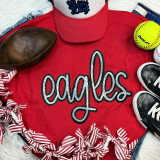Eagles Sequin Patch, detailed image of an eagle sequin patch on a red t-shirt surrounded by sports shoes, a football, a yellow softball, denim jeans, and a red and white striped scrunchie, suitable for sports or fashion accessories.