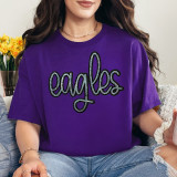 Eagles Sequin Patch, a shiny black and silver embroidered patch in the shape of the word 'eagles' worn on a purple T-shirt.