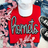 Hornets Sequin Patch, sparkling sequin embroidery patch spelling 'hornets' on red t-shirt surrounded by striped fabric ribbons, denim jeans, white cap, and sneakers.