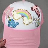 Axolotl Embroidered HAT/POCKET Patch, cute colorful patch featuring an axolotl, rainbow, star, unicorn, and cloud embroidered designs on a pink and white cap.
