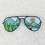 Sunglasses Embroidered HAT/POCKET Patch with scenic landscape design featuring mountains, trees, sun, and river embroidery details.