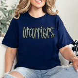 Warriors Sequin Patch, close-up of a woman wearing a navy blue T-shirt with a sequined 'Warriors' patch on the front.