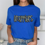 Warriors Sequin Patch, a blue t-shirt featuring the word "Warriors" in black sequined lettering with a colorful outline, worn by a model.