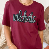 Wildcats Sequin Patch, maroon t-shirt with 'wildcats' embroidered in black and silver sequins.